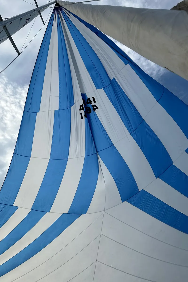 Slide: The Image of Blue and white striped sail of a 1985 C&C 41. - 27
