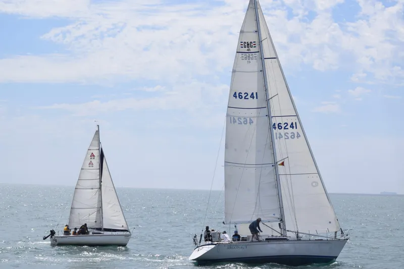 Slide: The Image of Two sailboats, including a 1985 C&C 41, sailing on open sea. - 3