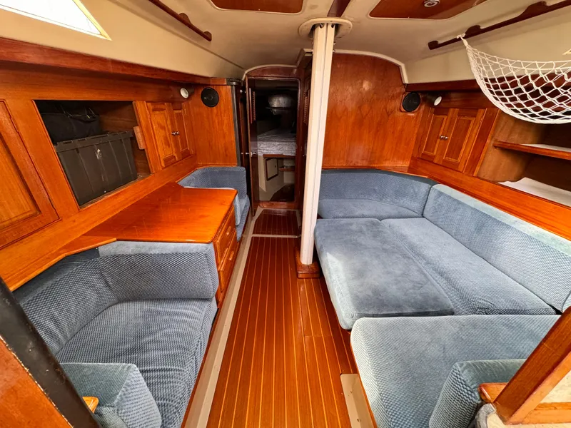 Slide: The Image of Interior of a 1985 C&C 41 yacht with blue upholstery. - 32