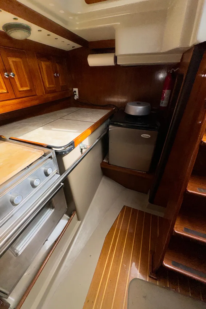 Slide: The Image of 1985 C&C 41 yacht interior with kitchen and wood paneling. - 36