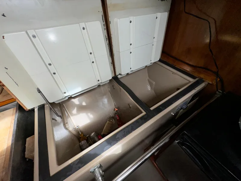 Slide: The Image of 1985 C&C 41 yacht kitchen area with open storage compartments. - 37
