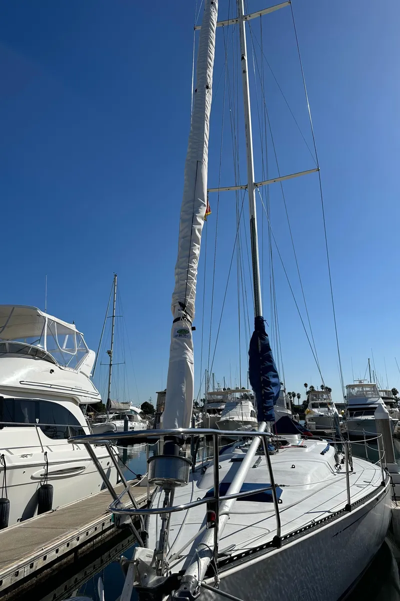 Slide: The Image of 1985 C&C 41 sailboat docked in marina under clear sky. - 4