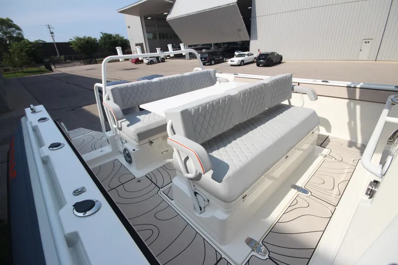 Slide: The Image of 2026 Zodiac X10CC boat interior with quilted seating and table, featuring modern design elements. - 11