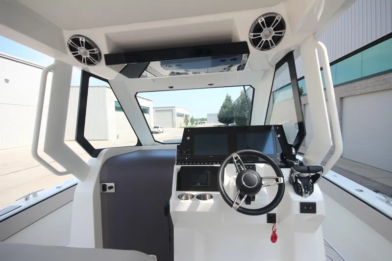 Slide: The Image of Interior view of 2026 Zodiac X10CC boat with advanced steering and joystick controls. - 17
