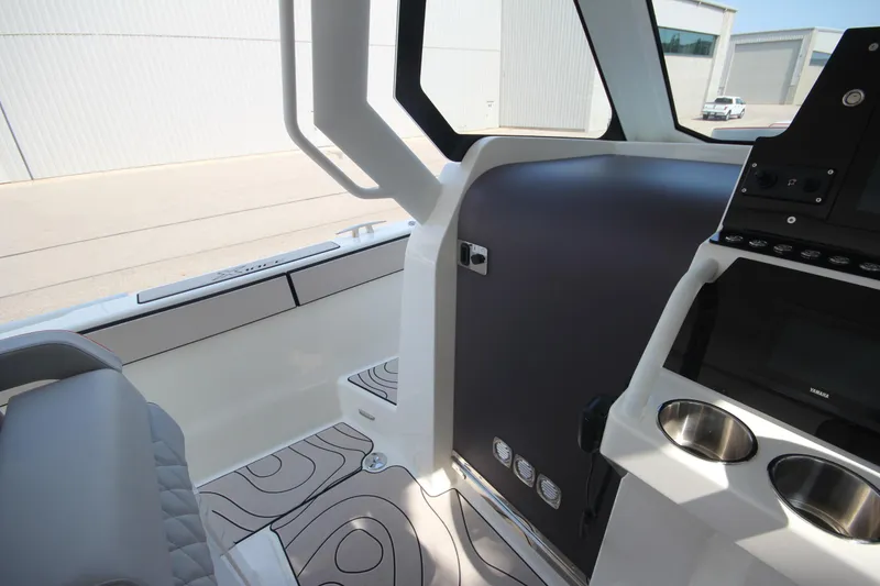 Slide: The Image of Interior of 2026 Zodiac X10CC boat with modern controls and seating. - 21