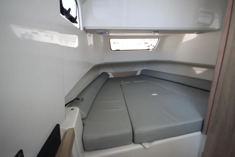 Slide: The Image of Interior cabin of 2026 Zodiac X10CC boat with comfortable seating and window view. - 23