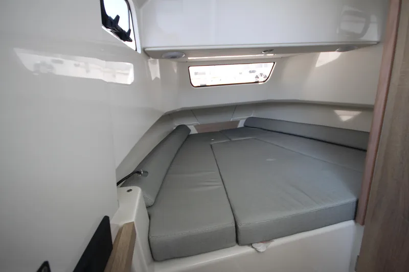 Slide: The Image of 2026 Zodiac X10CC cabin interior with gray cushions and window view. - 24