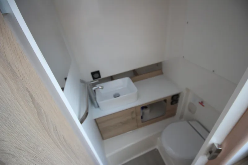 Slide: The Image of Compact bathroom interior of 2026 Zodiac X10CC boat with modern fixtures. - 28