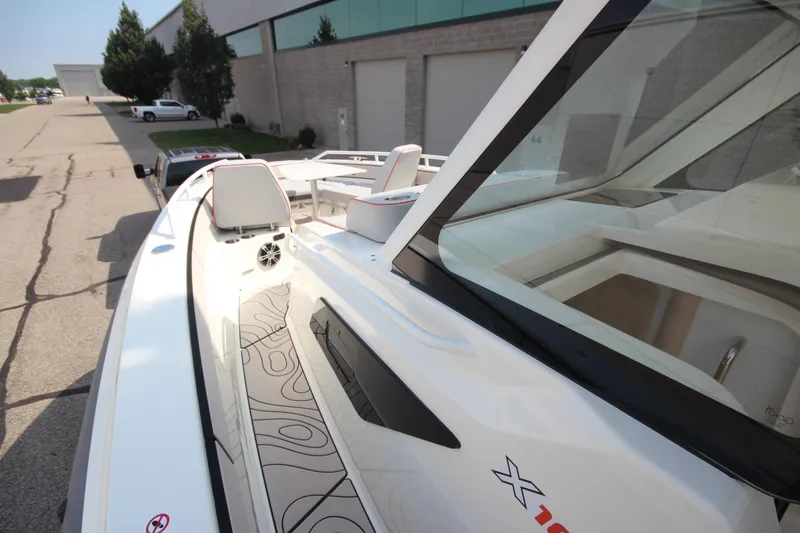 Slide: The Image of 2026 Zodiac X10CC boat with modern design and joystick control, docked outdoors. - 30