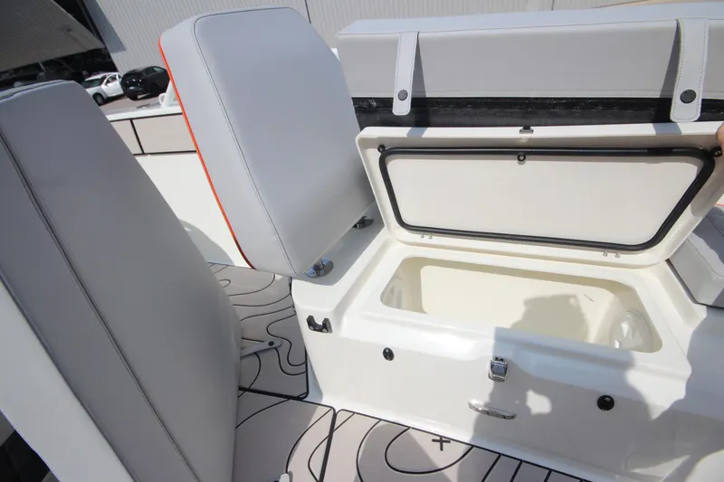 Slide: The Image of 2026 Zodiac X10CC boat interior with open storage compartment and cushioned seating. - 36
