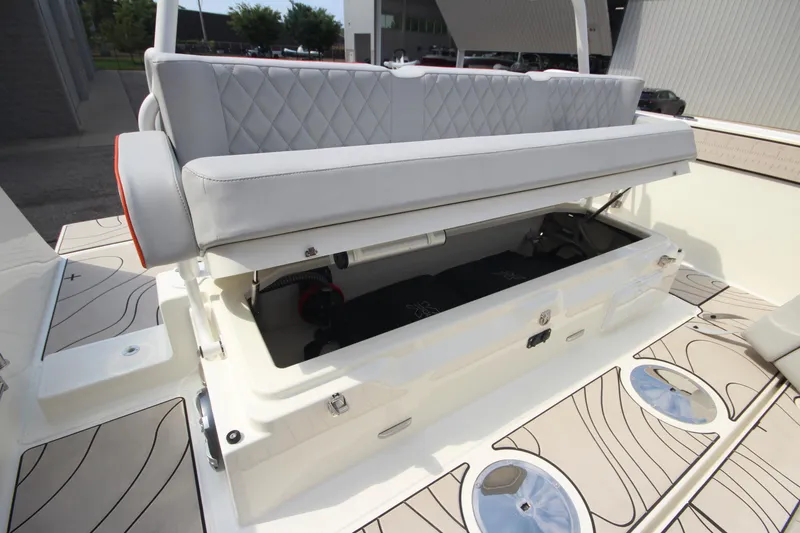 Slide: The Image of 2026 Zodiac X10CC boat with open storage compartment and cushioned seating. - 39