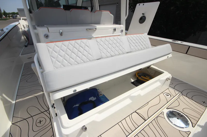 Slide: The Image of 2026 Zodiac X10CC boat with open storage compartment and cushioned seating. - 40