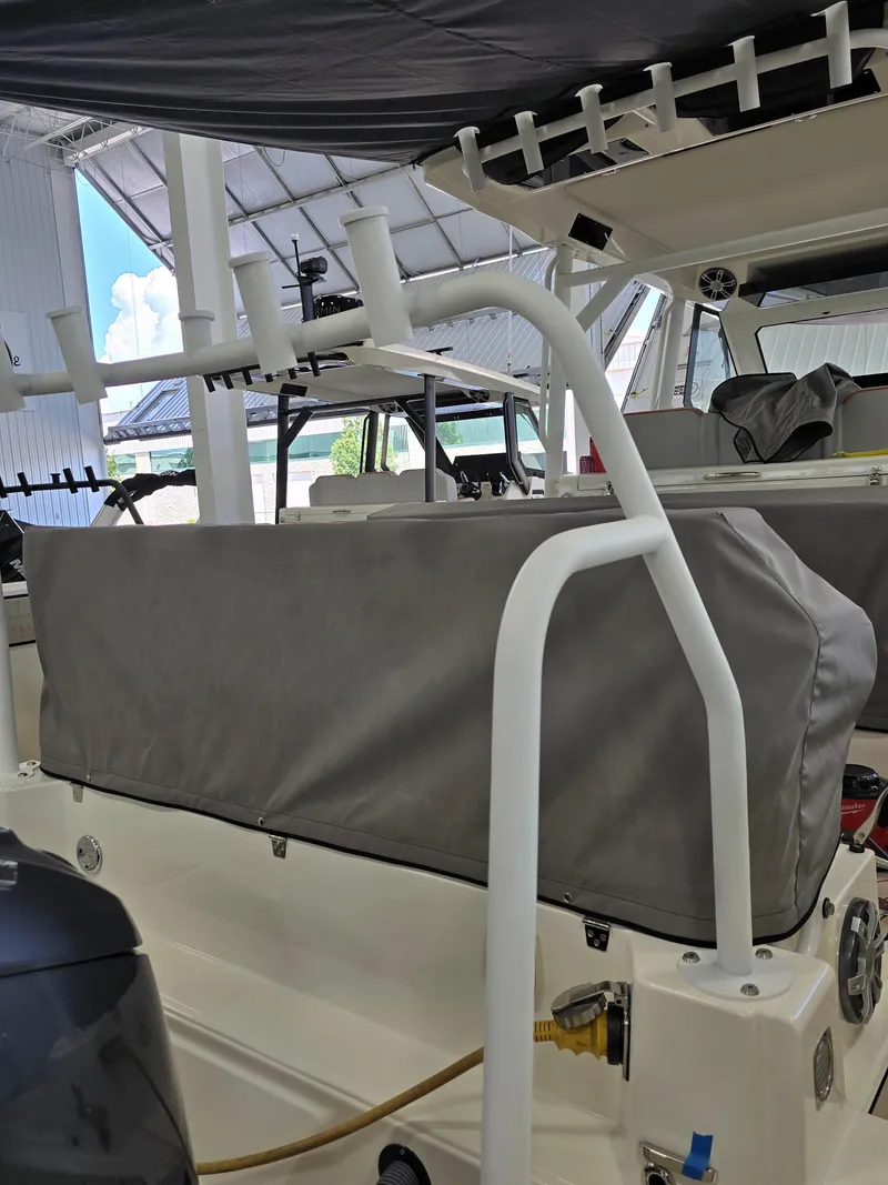 Slide: The Image of 2026 Zodiac X10CC boat interior with covered seating and rod holders. - 49