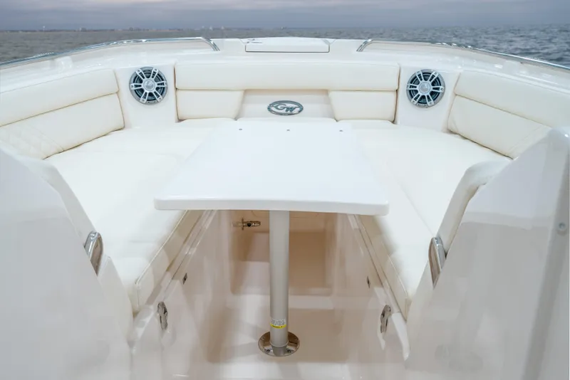 Slide: The Image of 2025 Grady-White Freedom 325 boat interior with seating and table on open water. - 12