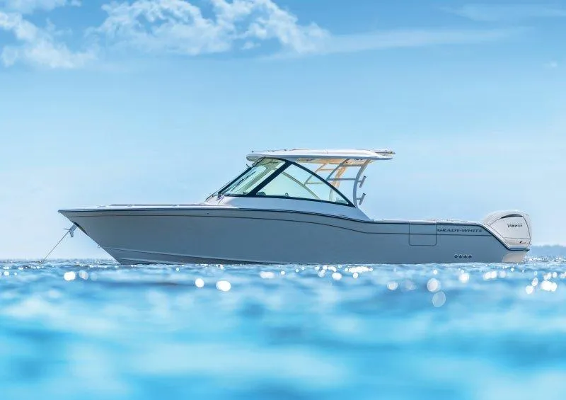 Slide: The Image of 2025 Grady-White Freedom 325 boat on clear blue water under a sunny sky. - 2