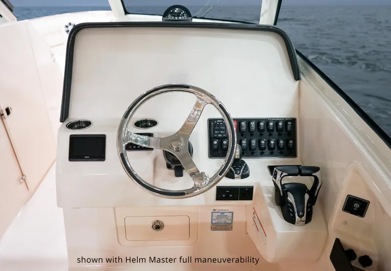 Slide: The Image of 2025 Grady-White Freedom 325 helm with advanced controls and Helm Master maneuverability system. - 7