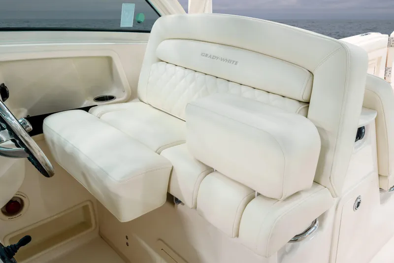 Slide: The Image of Luxury seating on 2025 Grady-White Freedom 325 boat, featuring plush white upholstery. - 8
