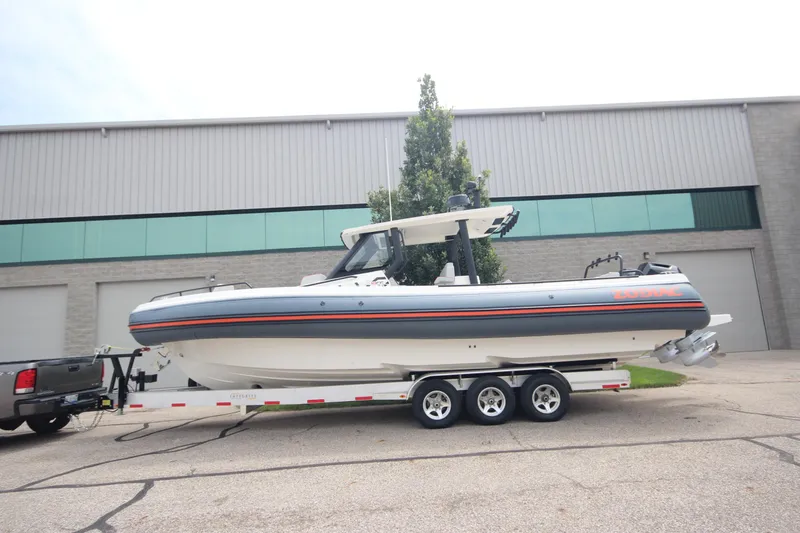 The Image of 2025 Zodiac X10CC boat on trailer, featuring twin Mercury 400 engines with joystick control. - 0