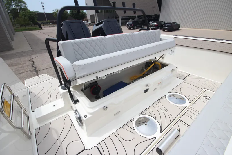 Slide: The Image of Modern Zodiac X10CC boat interior with seating and table, 2025 model, parked near a building. - 11