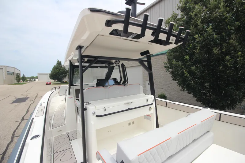 Slide: The Image of 2025 Zodiac X10CC boat with twin Mercury 400 engines and joystick, docked near a warehouse. - 16