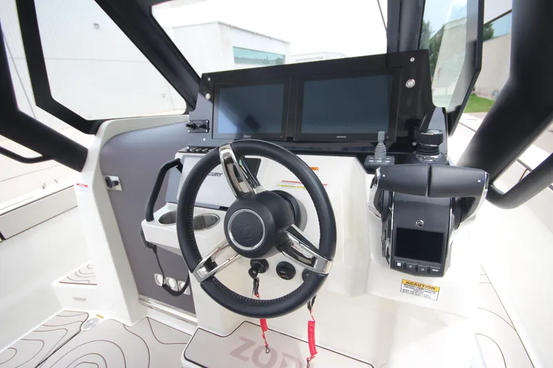 Slide: The Image of 2025 Zodiac X10CC boat interior with quilted seating and joystick controls. - 21