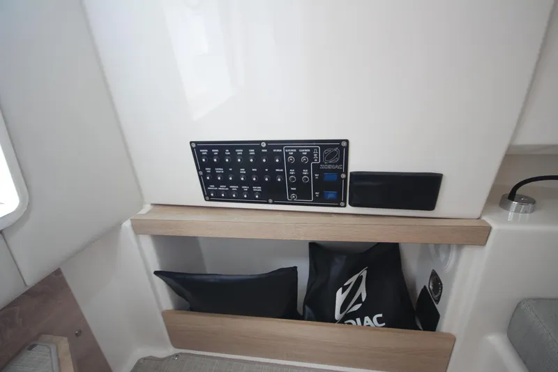 Slide: The Image of 2025 Zodiac X10CC cabin interior with gray cushioned seating and windows. - 26