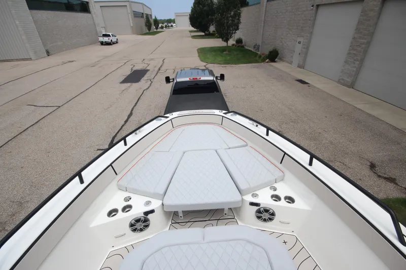 Slide: The Image of 2025 Zodiac X10CC boat storage compartment with open hatch and cushioned seating. - 35