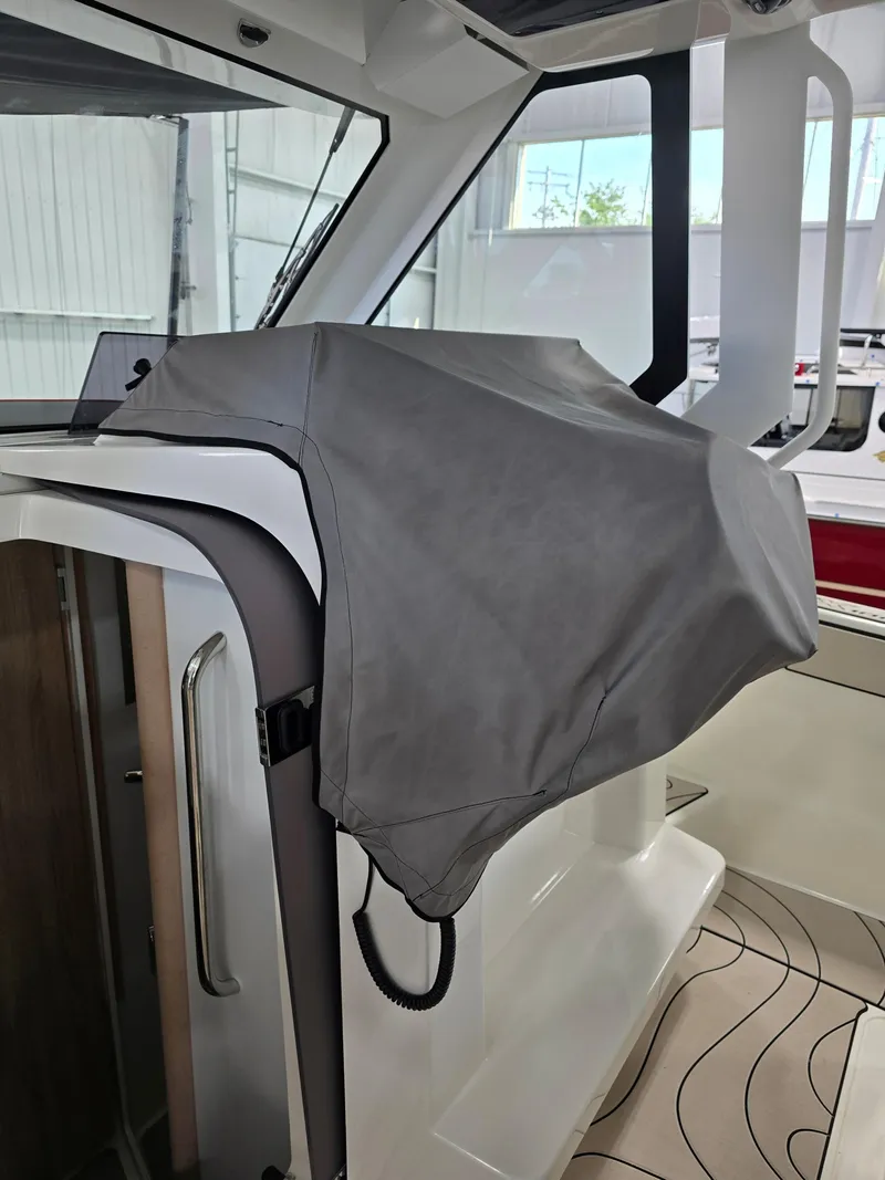 Slide: The Image of Covered control panel of 2025 Zodiac X10CC boat with joystick feature. - 44