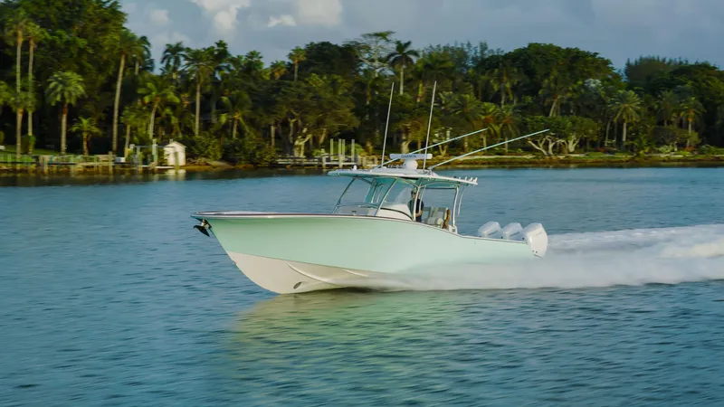 Slide: The Image of 2025 Mag Bay 38 Center Console boat cruising on a serene waterway. - 14