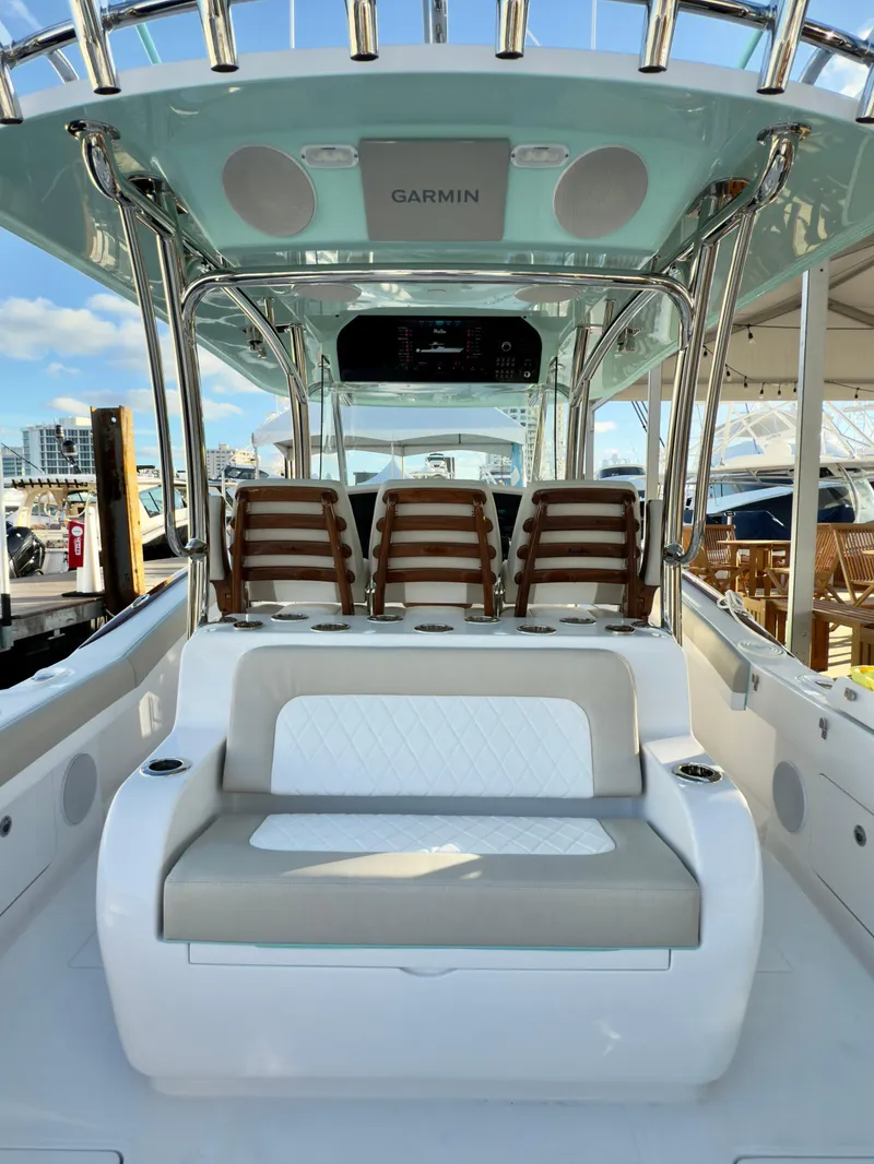 Slide: The Image of 2025 Mag Bay 38 Center Console boat interior with seating and Garmin equipment. - 38