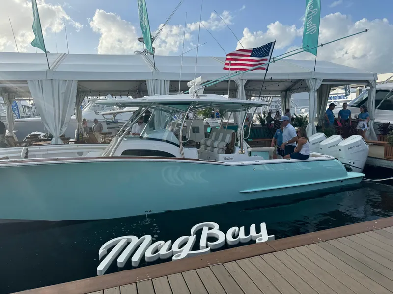 Slide: The Image of 2025 Mag Bay 38 Center Console boat docked at marina with American flag. - 25
