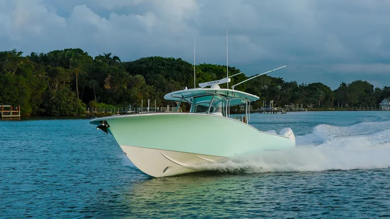 The Image of 2025 Mag Bay 38 Center Console cruising on a scenic waterway. - 0