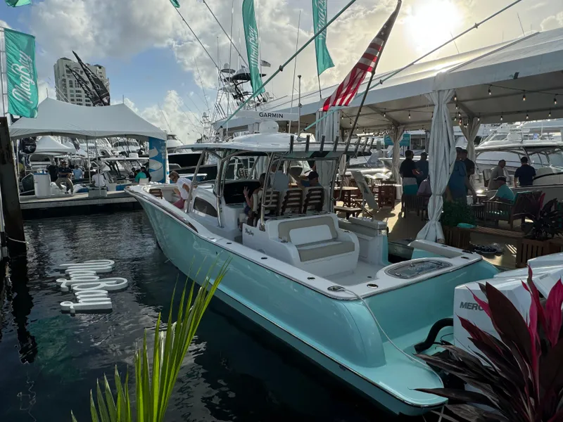 Slide: The Image of 2025 Mag Bay 38 Center Console boat displayed at a marina event. - 26