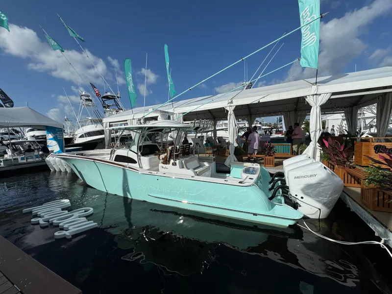 Slide: The Image of 2025 Mag Bay 38 Center Console boat docked at marina under blue sky. - 20