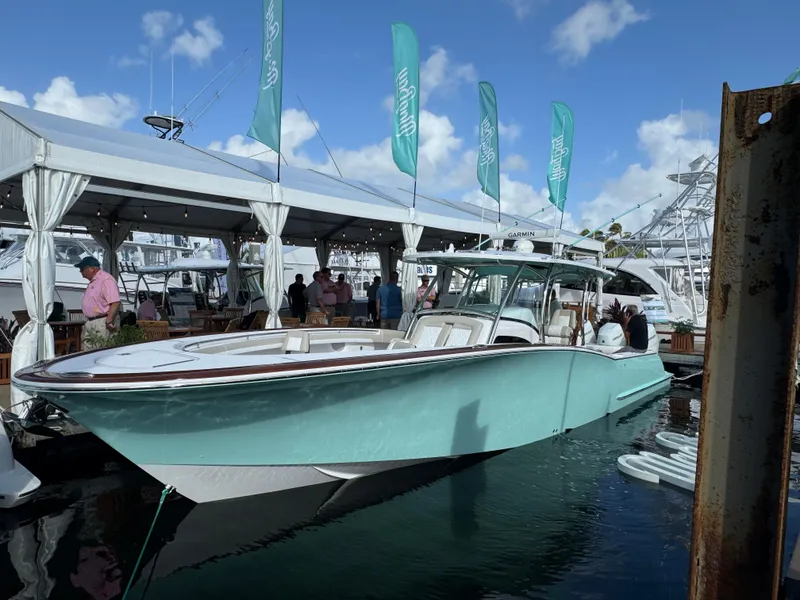 Slide: The Image of 2025 Mag Bay 38 Center Console boat displayed at a marina event. - 28