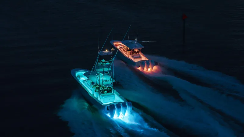 Slide: The Image of 2025 Mag Bay 38 Center Console boats illuminated at night on the water. - 16