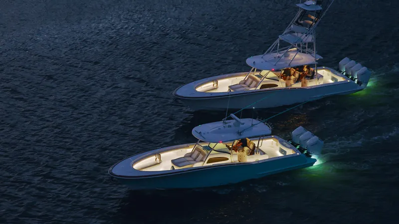 Slide: The Image of 2025 Mag Bay 38 Center Console boats illuminated on water at night. - 15