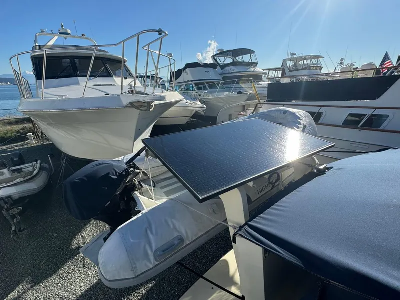 Slide: The Image of 1984 Tollycraft 48 Cockpit Motor Yacht with solar panel, docked among other boats. - 10