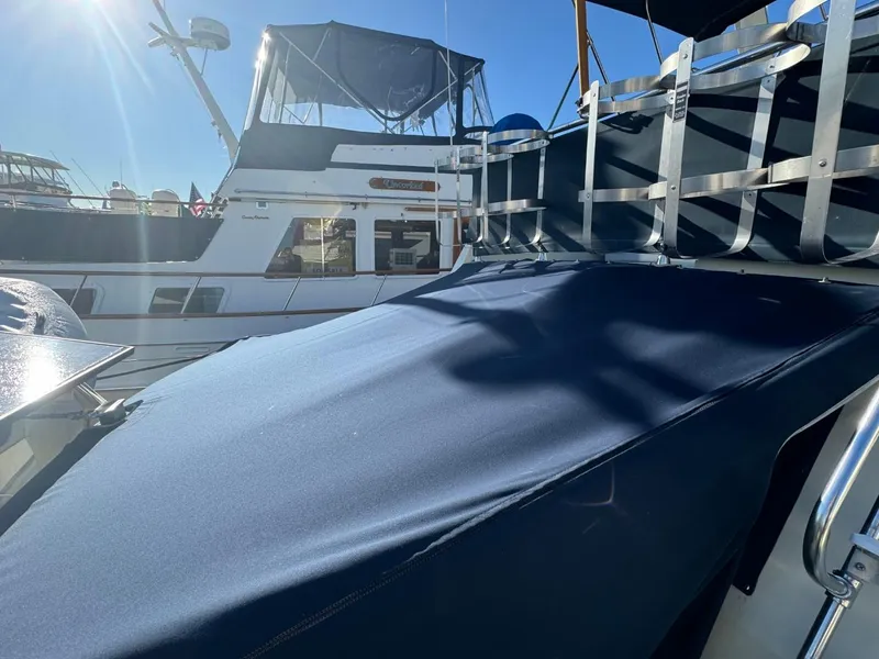 Slide: The Image of 1984 Tollycraft 48 Cockpit Motor Yacht docked under clear blue sky. - 11