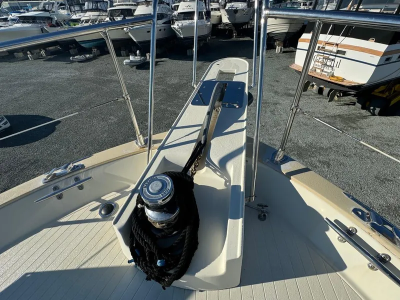 Slide: The Image of 1984 Tollycraft 48 Cockpit Motor Yacht bow with anchor and winch, docked among other boats. - 13