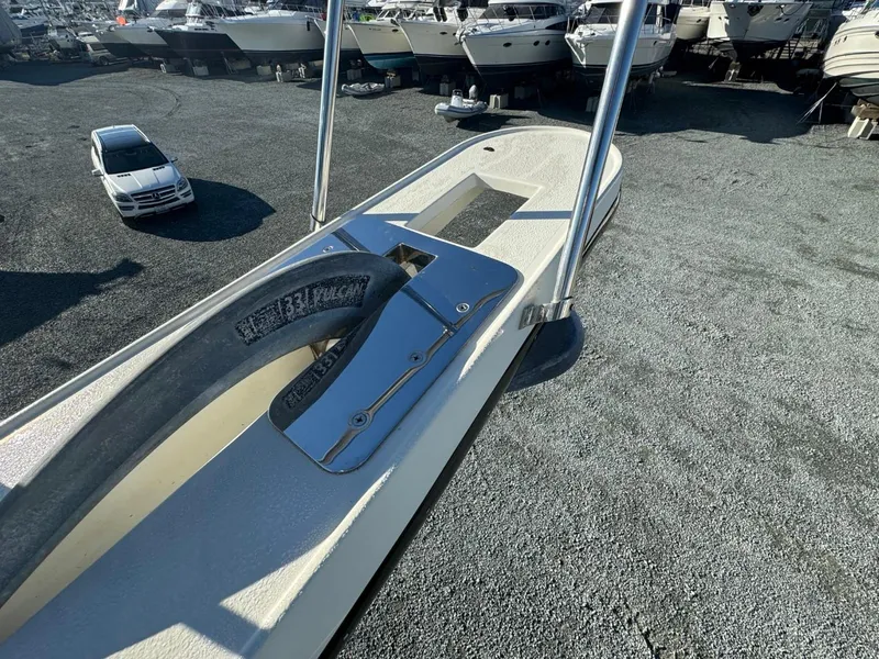 Slide: The Image of 1984 Tollycraft 48 Cockpit Motor Yacht on gravel lot with other boats. - 14