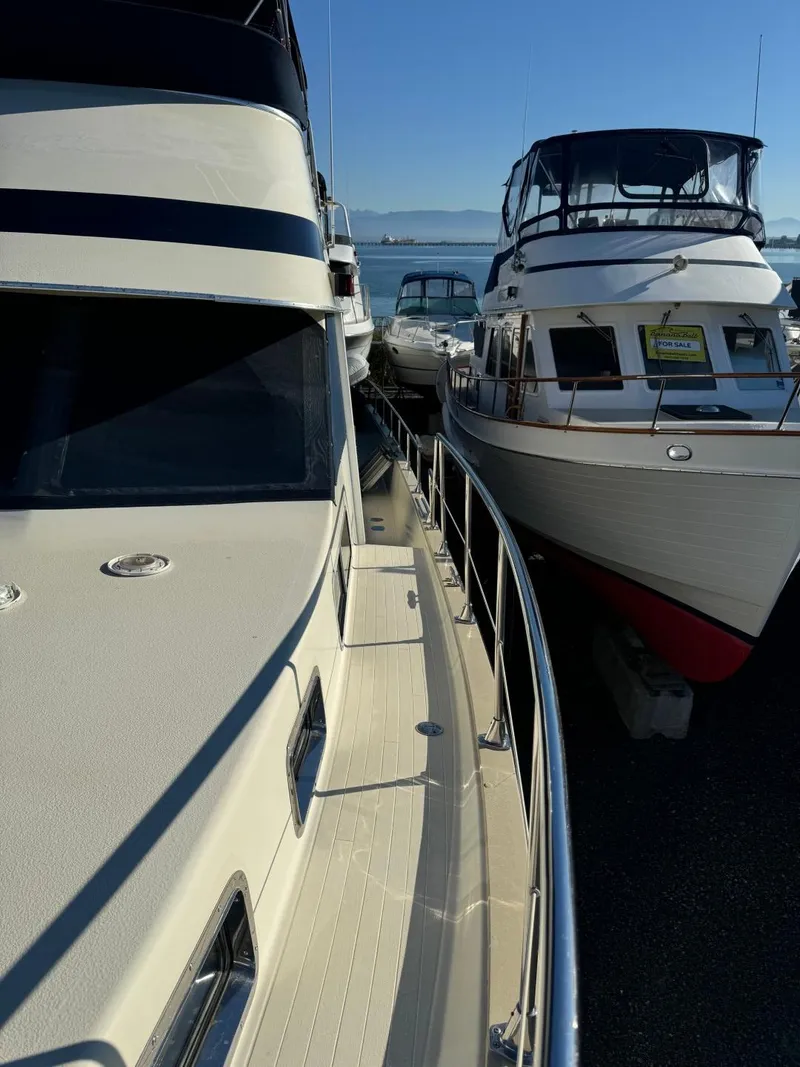 Slide: The Image of 1984 Tollycraft 48 Cockpit Motor Yacht docked alongside similar vessels. - 16