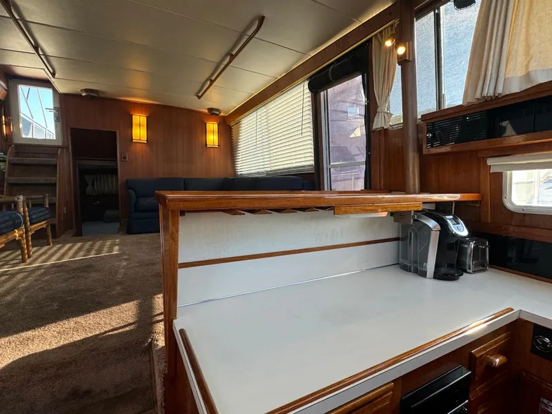 Slide: The Image of 1984 Tollycraft 48 Cockpit Motor Yacht interior with kitchen and lounge area. - 23
