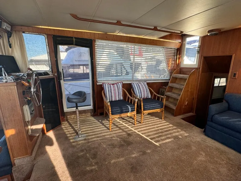 Slide: The Image of 1984 Tollycraft 48 Cockpit Motor Yacht interior with seating, helm, and stairs. - 24