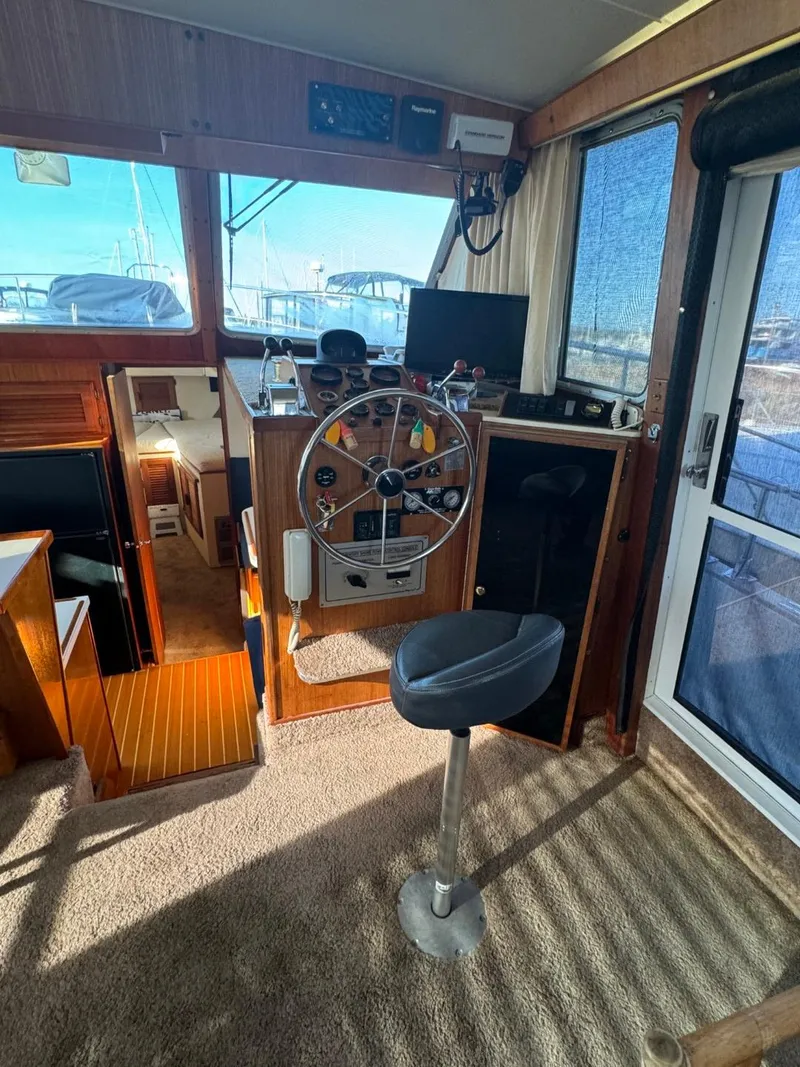 Slide: The Image of 1984 Tollycraft 48 Cockpit Motor Yacht interior with helm, stool, and navigation equipment. - 26