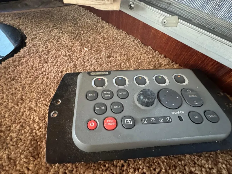 Slide: The Image of Control panel on 1984 Tollycraft 48 Cockpit Motor Yacht, featuring navigation and radar buttons. - 30