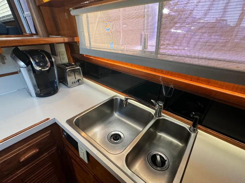 Slide: The Image of 1984 Tollycraft 48 Cockpit Motor Yacht kitchen with dual sinks and appliances. - 41