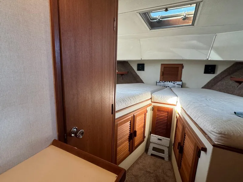 Slide: The Image of 1984 Tollycraft 48 Cockpit Motor Yacht interior cabin with twin beds and skylight. - 47