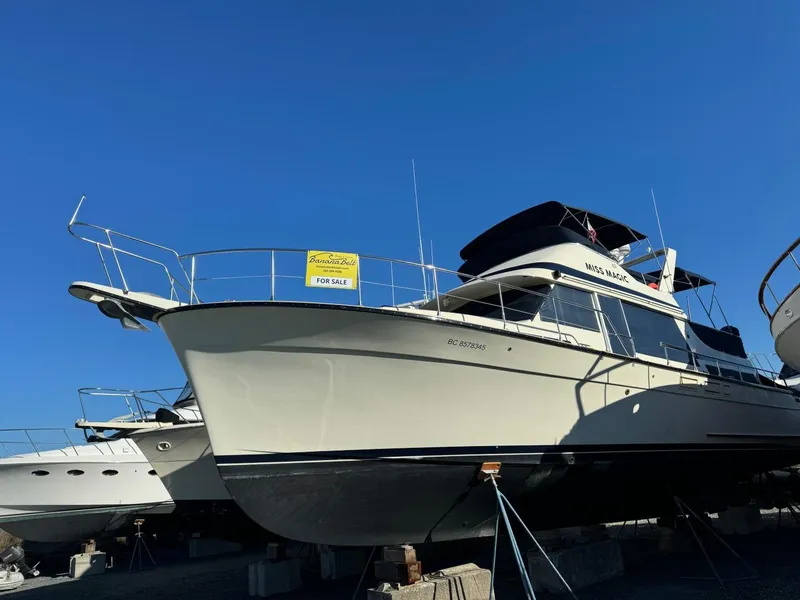 Slide: The Image of 1984 Tollycraft 48 Cockpit Motor Yacht for sale, docked under clear blue sky. - 5