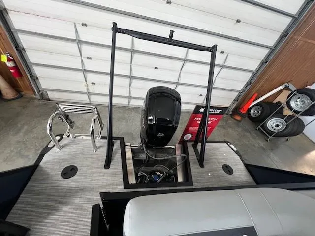 Slide: The Image of 2025 Viaggio Lago V 18 boat with motor and ladder in a garage setting. - 10